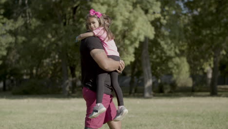 Tracking-shot-of-dad-with-disability-carrying-girl-in-arms